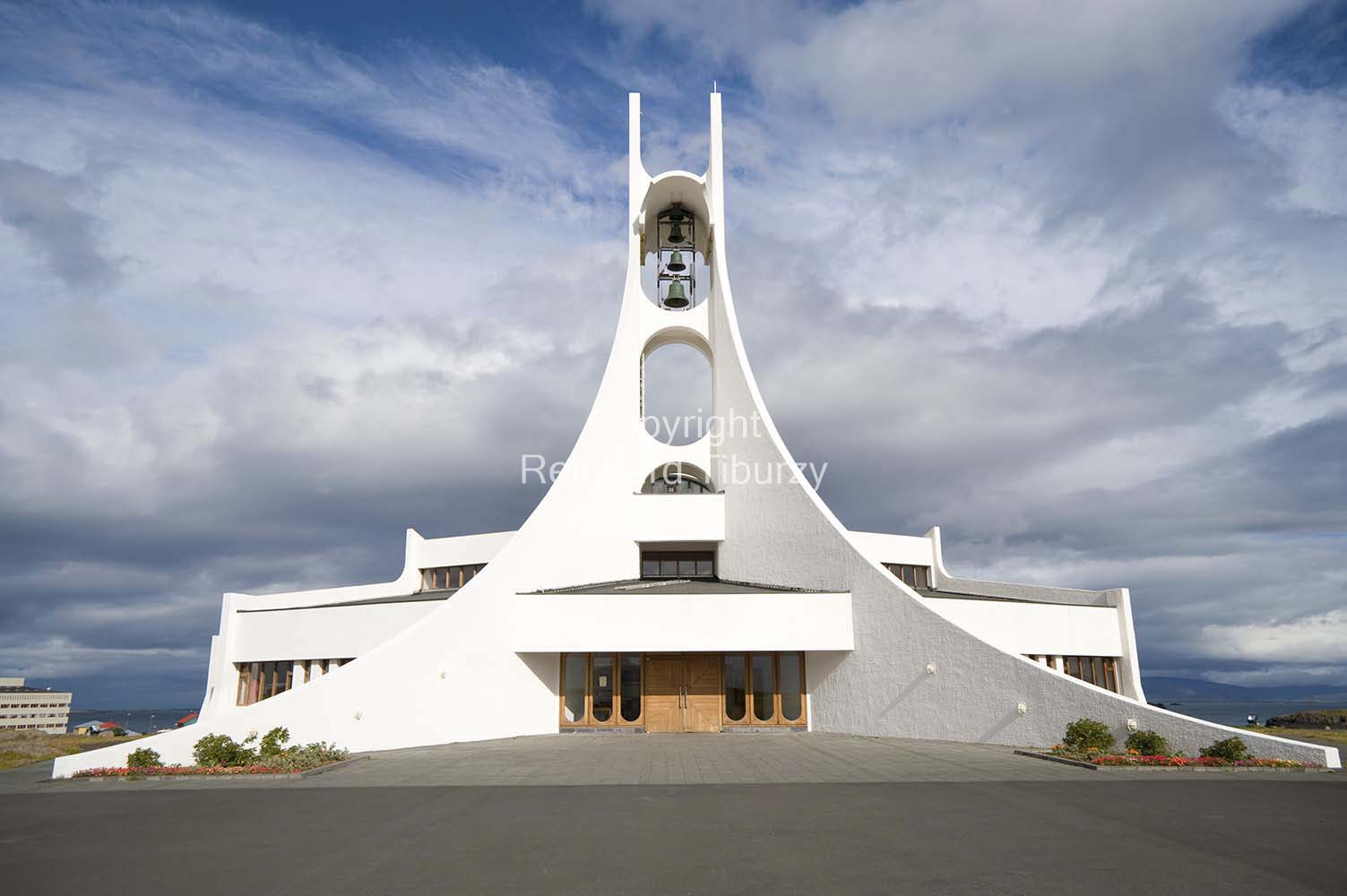The Stykkisholmskirkja, designed by Jon Haraldsson, is a modern white church at Stykkisholmur. Consecrated 1990